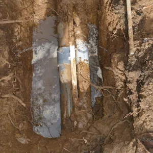 Broken 4 inch irrigation water pipe in Porter Trail section, taken from south side of hole.