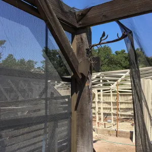 Repair of Garden Growers shade structure looking northwest