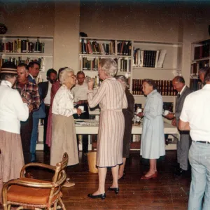 Man in plaid shirt facing camera: Dick Broder. Woman left of Mrs. Eaton (center): Elizabeth Tilt. Woman right of Mrs. Eaton in blue dress: Mrs. Elizabeth de Forest. Behind Mrs de Forest & Paul Koylas & man far right to camera: Bruce van Dyk