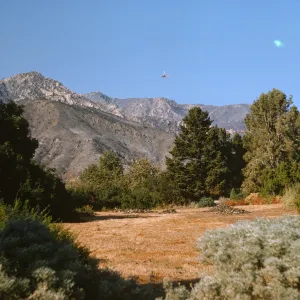 View of helicopter seeding Santa Ynez Mountains after Coyote Fire
