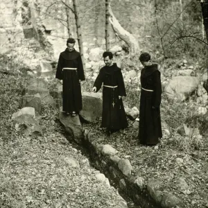 Mission Padres viewing the old Mission Aqueduct, 1940's
