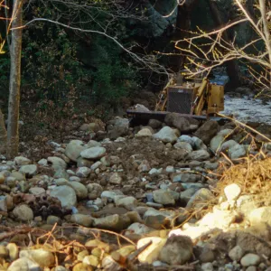 Mission Creek flooded above Mission Dam, with a bulldozer in background