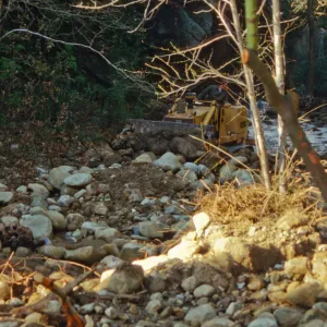 Mission Creek flooded above Mission Dam, with a bulldozer in background