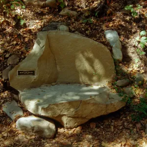new stone bench with plaque, on west side of Mission Dam, exposed tiles