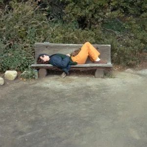 visitor lying on redwood bench, west side of Meadow, Meadow Oaks, Manzanita glauca, dirt path