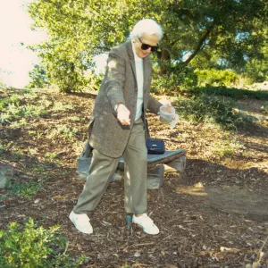 Ann Jones sowing wildflower seeds, Porter Trail, wood bench