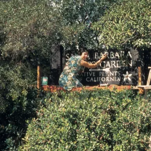 Jacqueline Broughton painting the entrance sign